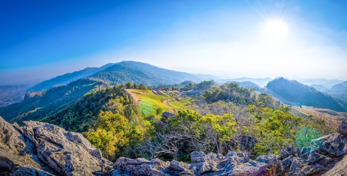 panorama view on high mountain landscape with sun in daylight time and lens flare effect