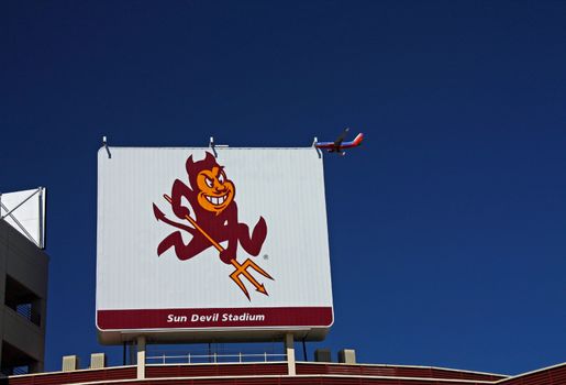 TEMPE - OCT 02 :  The Arizona State University Sun Devils football stadium sign with a Southwest Airlines plane passing. Taken October 02, 2011 in Tempe, AZ.