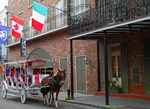 NEW ORLEANS - SEP 07 : Guide Colin Tyler conducts a buggy tour of the French Quarter of New Orleans . Taken September 07, 2013 in New Orleans, LA.