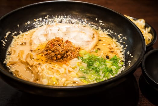 ramen japanese food style roasted pork and spicy ground pork sauce with onion sliceed noodle in soup sesame on topping