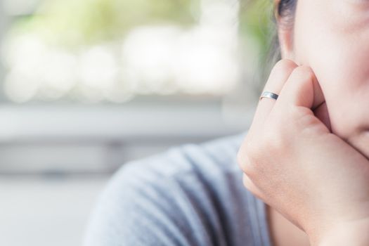 silver ring in finger of woman with blur background