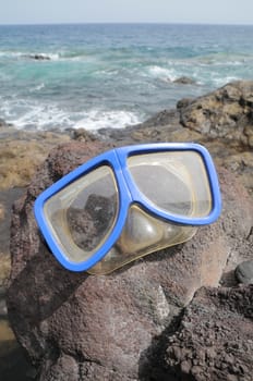 Blue Old Diving Mask on the Rocks near the Beach