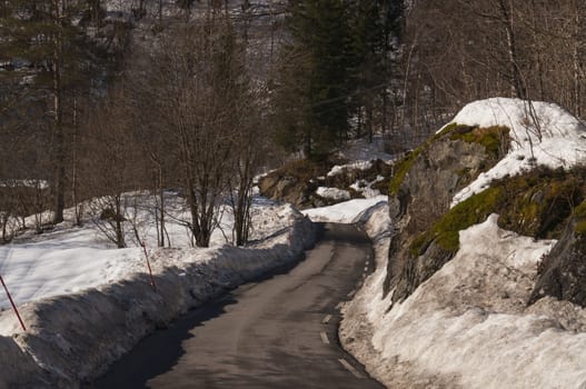 A snow plowed narrow country road