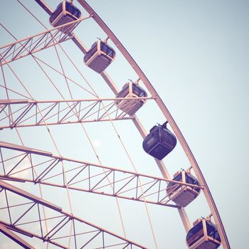 Ferris wheel and blue sky with retro filter effect 
