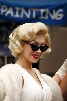 HOLLYWOOD, CA, USA - SEPTEMBER 17, 2011: Blond girl model like Marilyn Monroe in car on 17 September, 2011 in the Universal Studios Hollywood.