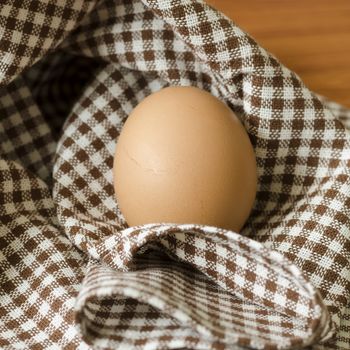 egg in kitchen towel on table