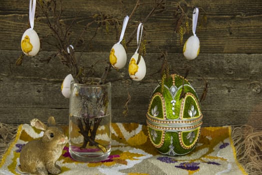 Easter decoration with birch branches ina vase, eggs and a rabbit