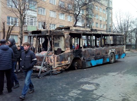 KHMELNYTSKY, UKRAINE - FEBRUARY 20: Unidentified protesters, burned trolleybus near Ukraine Security Service department  on February 20,  2014 in Khmelnytsky, Ukraine