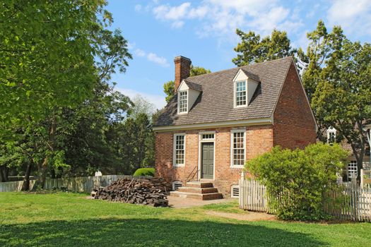 WILLIAMSBURG, VIRGINIA - APRIL 21 2012: A small brick building in the center of Colonial Williamsburg in Virginia. The restored town is a major attraction for tourists and meetings of world leaders.