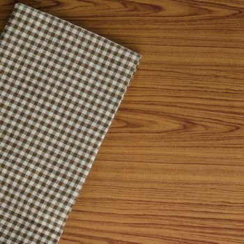 brown kitchen towel pattern on wood background