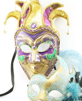 Two isolated Mardi Gras masks.