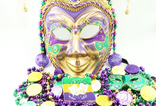 Mardi Gras mask with beads and doubloons.