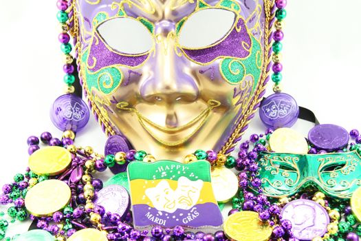 Mardi Gras mask with beads and doubloons.