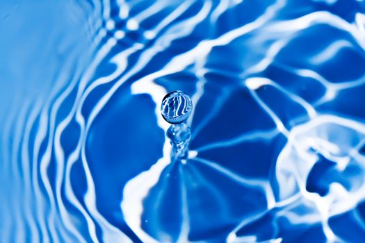 Blue transparent water splashes on white background