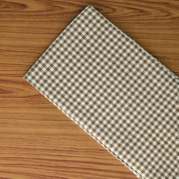 brown kitchen towel pattern on wood background