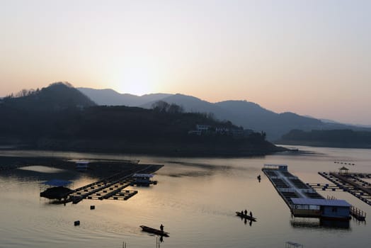 Landscape of sunset on a lake with boats