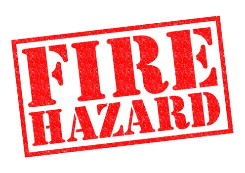 FIRE HAZARD red Rubber Stamp over a white background.