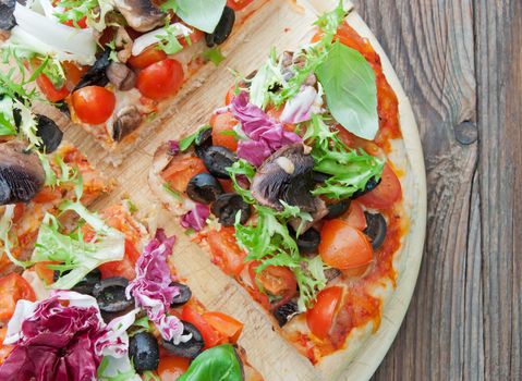 Stone baked pizza cut into slices on a chopping board