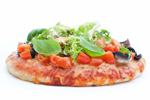 Deep pan pizza topped with basil, tomatoes and mushrooms over a white background 