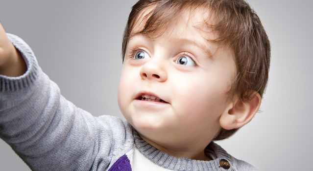 Child looking away from the camera smiling