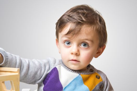 Child staring at the camera on white background