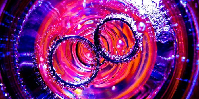 Abstract image of two rings submerged with vibrant colors