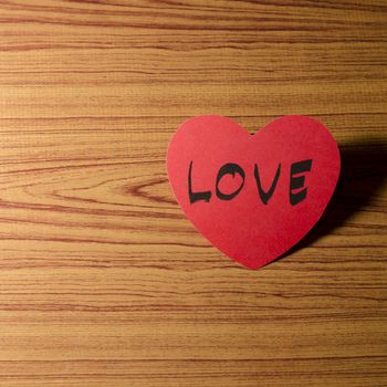 red heart word LOVE on wood vintage stlye background