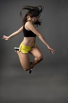 Fitness active girl jump over grunge background