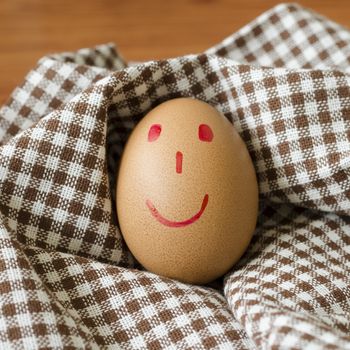 smile love egg couple in brown kitchen towel on wood table