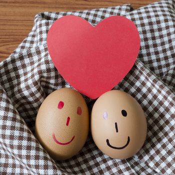 smile love egg couple in brown kitchen towel on wood table