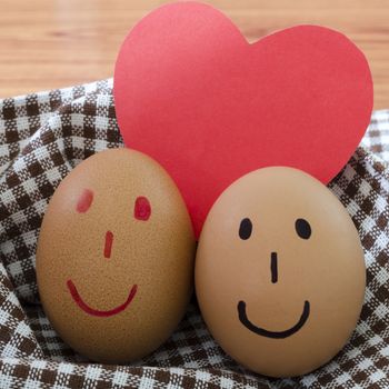 smile love egg couple in brown kitchen towel on wood table