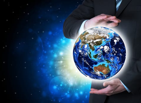 Man in suit holding a earth in hand. The concept of globalization