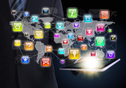 Man in suit holding tablet in hand. Application icons around tablet. The concept of software