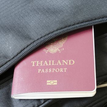 thai passport in black bag