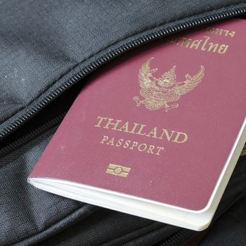 thai passport in black bag