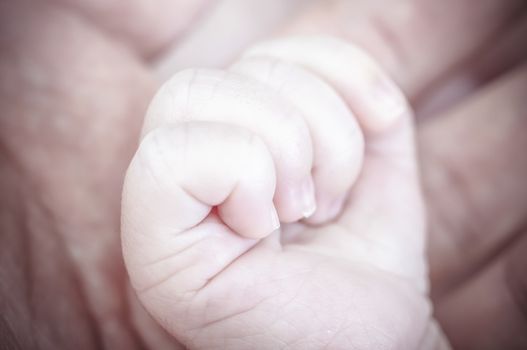 Hand, new born baby curled up sleeping on a blanket, multiple expressions