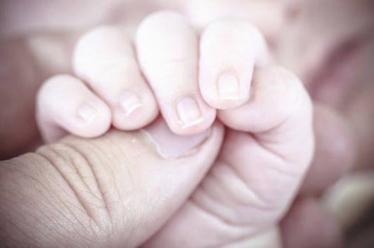 Hand, new born baby curled up sleeping on a blanket, multiple expressions