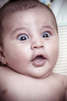 new born baby curled up sleeping on a blanket, multiple expressions