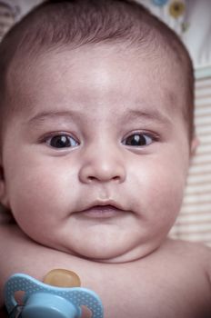 Pacifier, new born baby curled up sleeping on a blanket, multiple expressions