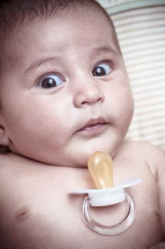 Pacifier, new born baby curled up sleeping on a blanket, multiple expressions