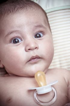 Pacifier, new born baby curled up sleeping on a blanket, multiple expressions