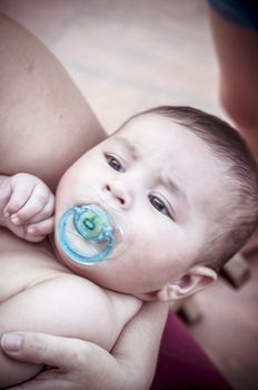 Pacifier, new born baby curled up sleeping on a blanket, multiple expressions