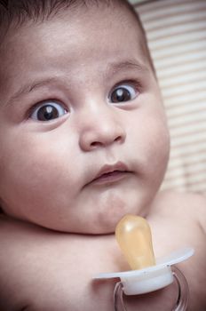 Pacifier, new born baby curled up sleeping on a blanket, multiple expressions