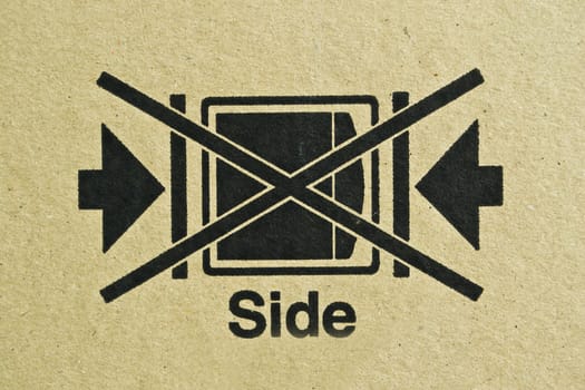 Black symbol on cardboard, brown paper box