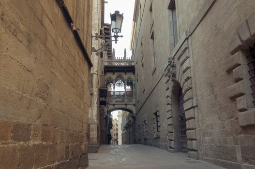 famous Gothic Quarter in barcelona with narrow medieval streets; focus on foreground wall
