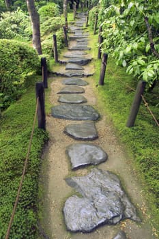 wet stone pathway in Japanese Zen garden  by summer