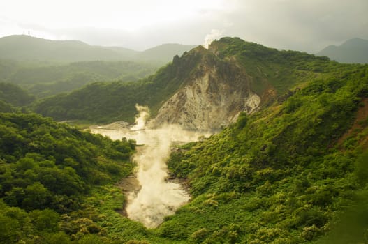 summer landscape with hot steam volcanic activity in Noboribetsu area of Hokkaido island in Japan
