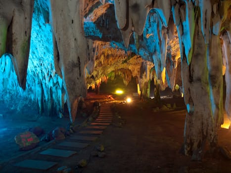 Stalactite wall illuminated with color light in Tham Khao Bin cave, Ratchaburi, Thailand