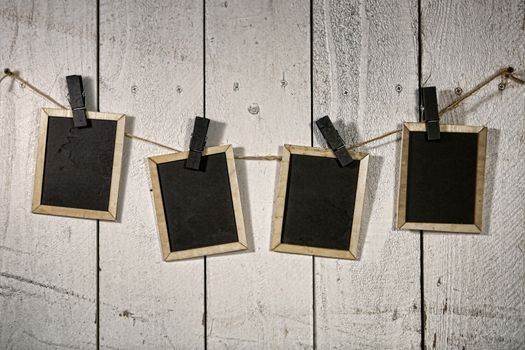 Old Film Looking Chalkboards Hanging on a Rope Held By Clothespins