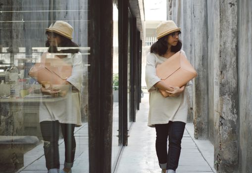 Young fashion girl with handbag at alleyway